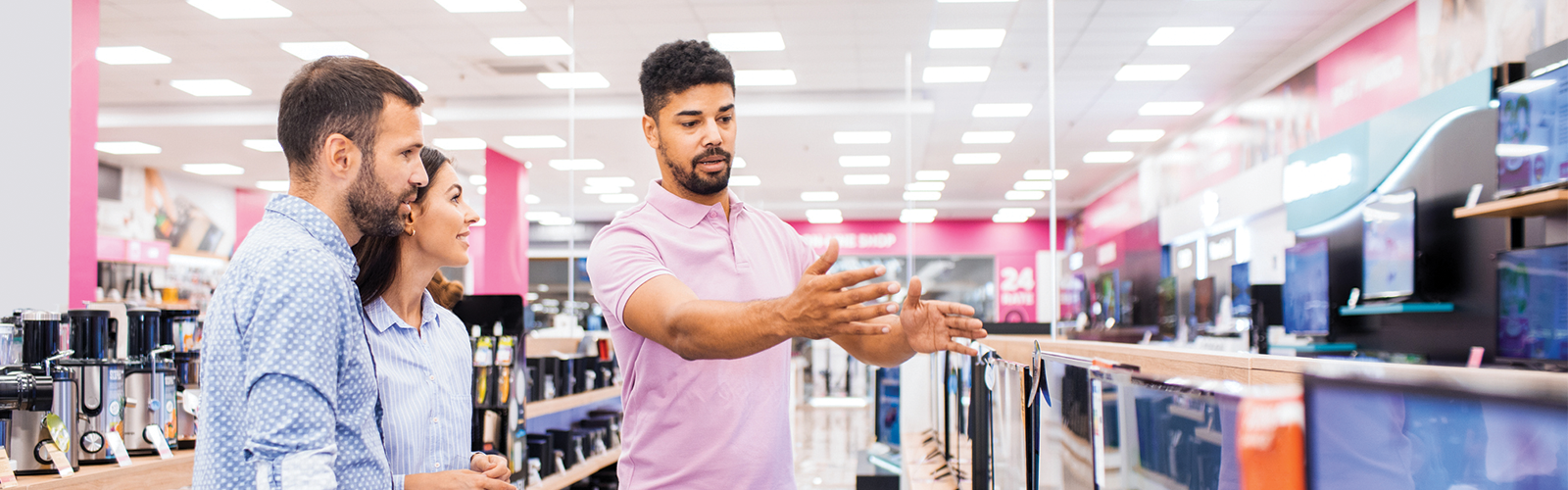 Male customer associate showing a couple inventory in his store