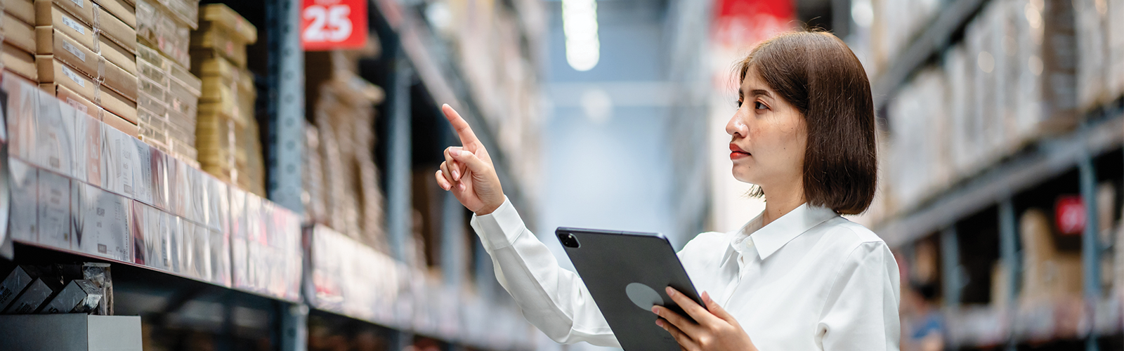 Female associate checking back inventory on a tablet