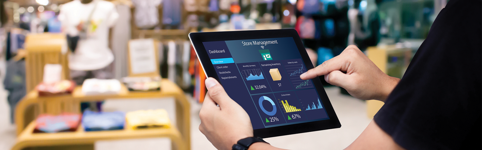 Male associate showing stats about store management on his tablet