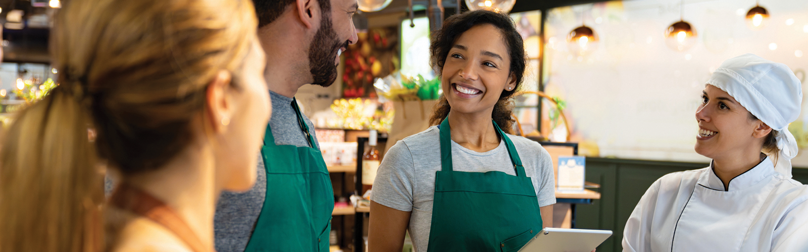 Group of associates in a grocery store meeting with each other