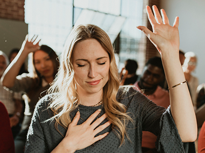 Woman praising in a church