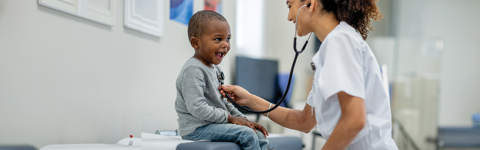 Female doctor checking the heartbeat of a child patient