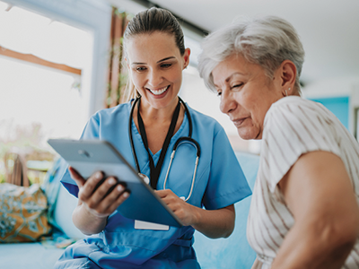 A doctor showing a patient a tablet screen