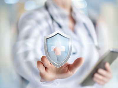 Doctor tapping a graphic of a shield with a logo of a medical cross on it