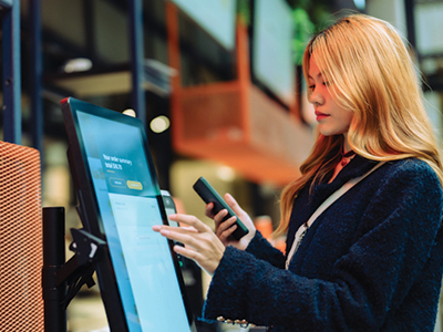 Female customer using a self-serve POS system