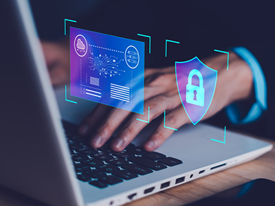 Photo of man's hands on a laptop with a lock icon floating in front of the laptop