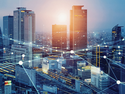 A city skyline with graphics of lines and circles connecting, simulating internet connections