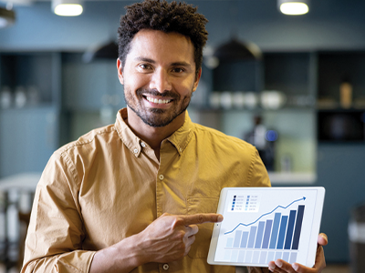 A man holding a tablet with a graphic of an exponential graph on the screen