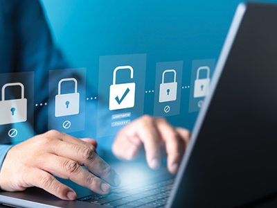 A pair of hands on a laptop with a graphic of locks and password entries
